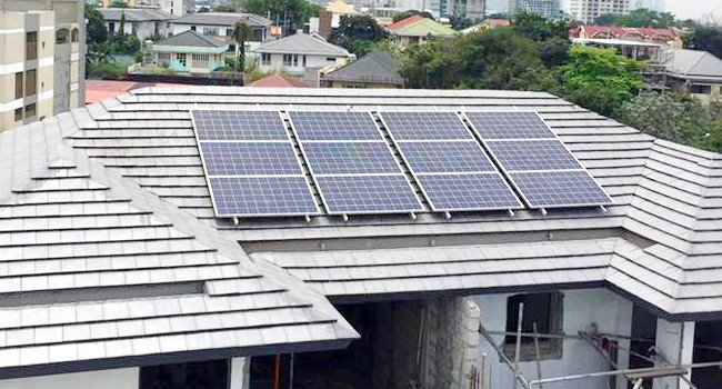 Flat roof tiles with solar panels on a residential property