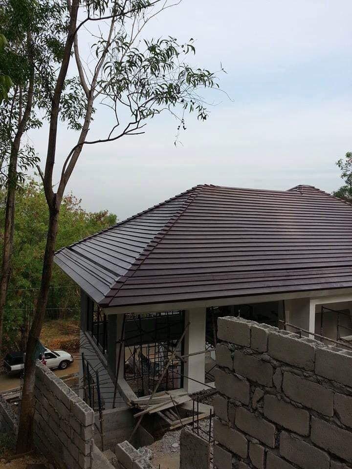 Concrete roof tile hip roof on a house under construction