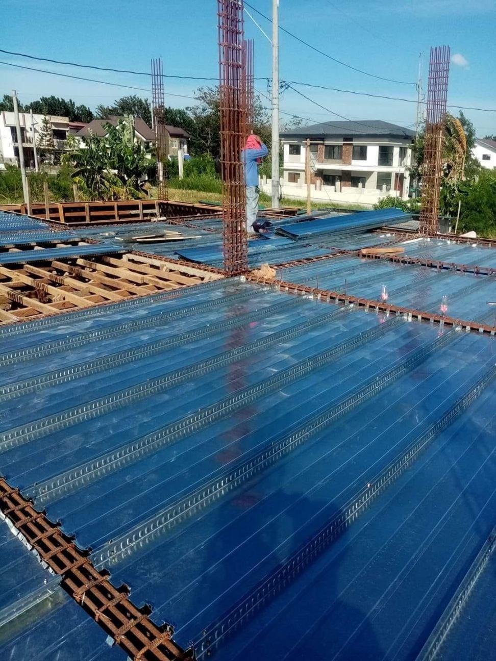Polycarbonate roofing sheet installation on a construction site